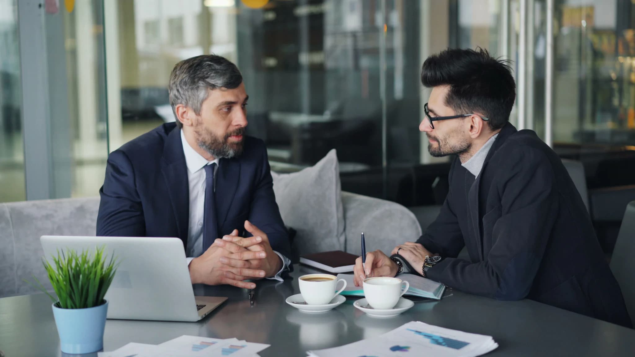Two professionals discussing a project in a collaborative workspace.